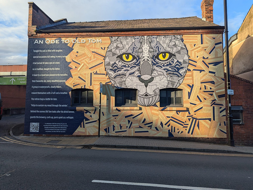 Gregory's poem on a pub wall with the face of the cat Old Tom